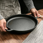 Black cast iron Human showing Black Non-Stick Griddle Pan