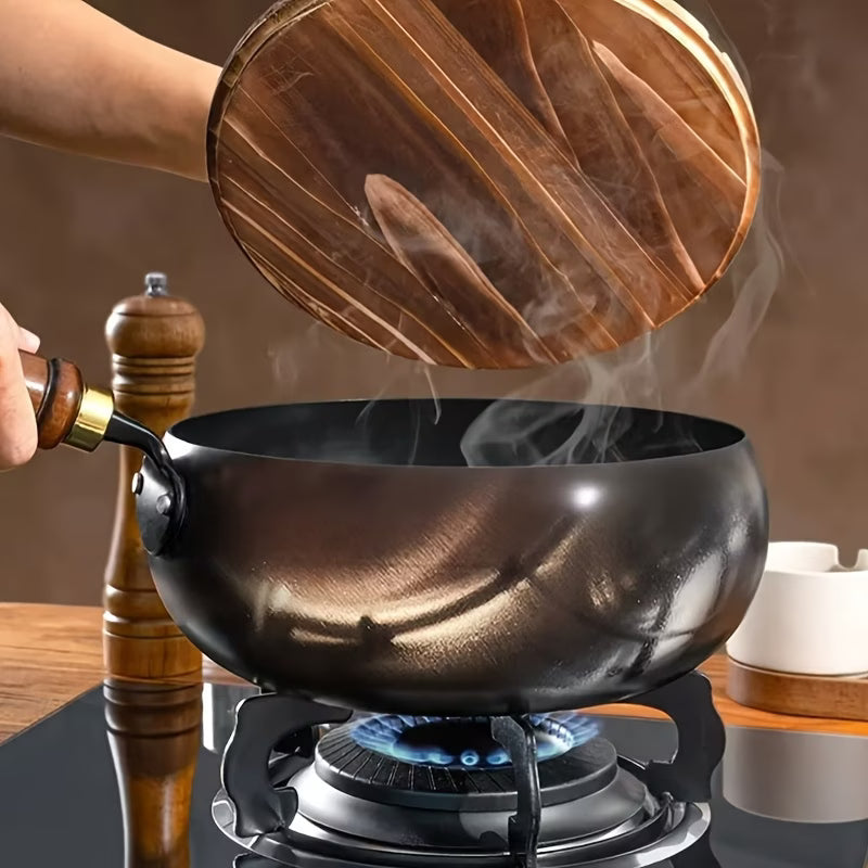 Fenn cast iron pot with wooden lid lifted, steam rising on stovetop