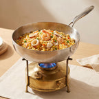 Fenn forged hammered multi-pan filled with seafood fried rice, cooking on a tabletop gas burner